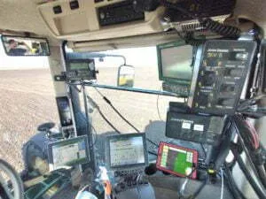 Picture of multiple computers in the cab of a tractor that are used in precision agriculture